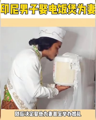 这张图是一则网络搞笑新闻梗图，画面中一位穿着传统服饰的男子，正与一个穿上婚纱的电饭煲举行形象上的“婚礼”。图片顶部和底部分别有黄色大字新闻标题和说明，内容讲述该男子决定娶电饭煲为“妻”，并举办了婚礼。搞笑点在于将家用电器拟人化，与人类发生离谱关系，造成强烈反差，充满幽默和讽刺。