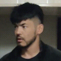 这是一张AI生成的动态GIF图，图中一位留着深色短发、身着黑色上衣的男性，他的胡子形态与嘴部状态持续动态切换，呈现出从疑惑、抿嘴到平静等多种不同的面部神态，属于无对白的表情素材，可用于表达纠结、无语等复杂情绪，图中没有双关、谐音梗等内容。