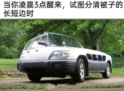 这张梗图上方配有文字「当你凌晨3点醒来，试图分清被子的长短边时」，下方是一张视觉错位的汽车图片：这辆汽车通过特殊的拍摄角度呈现出前后颠倒、方向混乱的怪异形态，精准对应了人在凌晨迷迷糊糊、大脑不清醒时，分不清被子方向的懵圈、混乱状态，用荒诞的视觉效果放大了这种深夜里的无奈与搞笑感。