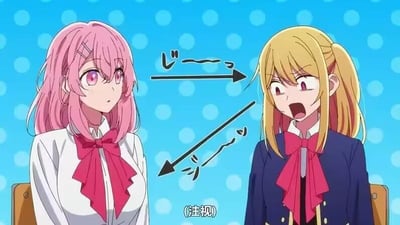 这是一张动画截图，画面左侧是粉发紫眼的女高中生有马加奈，她表情平静，正看向右侧；右侧是金发的星野露比，她眼睛瞪大、嘴巴张开，露出极度震惊的神情。图中用双向箭头搭配日文拟声词标注出两人互相注视的状态，下方还有中文注释“(注视)”，直观表现出两人对视的场景。右侧角色的夸张反应和左侧的平静形成鲜明对比，营造出尴尬又好笑的氛围，常被用来表达突然被注视的惊慌，或是看到意外事物时的震惊情绪，没有双关、谐音梗等内容。