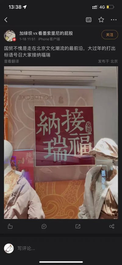 这是一张微博平台的帖子截图，发帖用户拍摄了北京国贸商场的春节橱窗：橱窗内张贴的红色春节标语原本是传统吉祥语“接福纳瑞”，但由于玻璃的镜面反射效果，从外部观看时文字完全翻转，视觉上看起来和“接纳福瑞”字样高度相似。“福瑞”是亚文化圈对“furry（兽人相关文化爱好者群体）”的中文谐音，发帖人以此玩梗，调侃国贸走在北京文化潮流的最前沿，大过年打出标语号召大家接纳福瑞，属于结合视觉错位和谐音梗的搞笑内容。