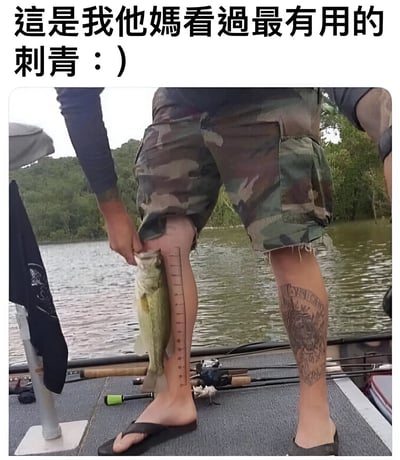 图片展示了一个站在船上的人，正用腿部的尺子纹身测量刚钓到的鱼的长度。上方文字写着'這是我他媽看過最有用的刺青 : )'，幽默地表达了这种创意纹身的实用性。