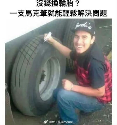 整张图为搞笑图文梗图，顶部配繁体文字“沒錢換輪胎？一支馬克筆就能輕鬆解決問題”，画面中一名戴着黑色帽子的男子蹲在已经磨损到纹路完全消失的汽车轮胎旁，手持白色马克笔在轮胎表面手绘模仿轮胎的防滑纹路，同时对着镜头露出开心的笑容，用这种完全无用、自欺欺人的搞怪操作调侃没钱更换配件时的投机取巧思路，内容荒诞搞笑，有较强的戏谑效果。