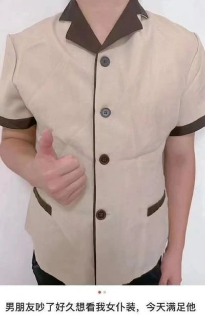 图片中展示了一位穿着卡其色制服的人，制服有棕色翻领和袖口，胸前有三颗纽扣，整体风格类似酒店或服务行业工作服。人物左手竖起大拇指，面部被裁剪未显示。图片底部配有文字：'男朋友吵了好久想看我女仆装，今天满足他'，通过将普通制服幽默地当作'女仆装'来呈现，形成期望与现实的反差萌效果，展现了情侣间的趣味互动。