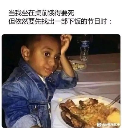 这是一张图文混排的静态单图，上方配有文字“当我坐在桌前饿得要死但依然要先找出一部下饭的节目时：”，下方是一张真实拍摄的照片：一个小男孩坐在餐桌前，面前摆着一盘看起来很丰盛的餐食，他一只手撑着头，眼神带着纠结又急切的神态，脸上还沾有食物残渣，生动地还原了明明已经极度饥饿，却因为没有找到合适的下饭节目，只能强忍着饿意等待的状态，精准戳中了当代人吃饭必须搭配视频、节目的普遍生活习惯，用幽默的方式调侃了这种日常行为。