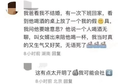 这是一张国内社交平台的评论截图，包含两条用户评论。第一条来自湖南的用户分享了自己的家庭趣事：因自己一直未婚，某天下班回家发现父亲喝酒的桌上摆放着一个自己的假阳具，询问父亲后，父亲调侃称自己一个人喝酒无聊，叫“女婿”出来陪喝一杯，该用户表示自己当时又生气又好笑，还配上了捂脸哭的表情符号。第二条是来自北京的用户评论，称这位父亲的做法太过开明，自己如果遇到这种情况会感到社死，同时配上了惊讶的表情符号。整个内容以幽默另类的方式展现了当代长辈对子女婚姻问题的关注，充满趣味和笑点。