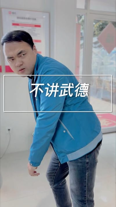 图片中是马保国穿着蓝色外套，身体前倾做出武术姿势，图片中央有白色文字'不讲武德'。这是源自2020年马保国比武失败视频的网络迷因，现用于调侃不按套路出牌的行为。