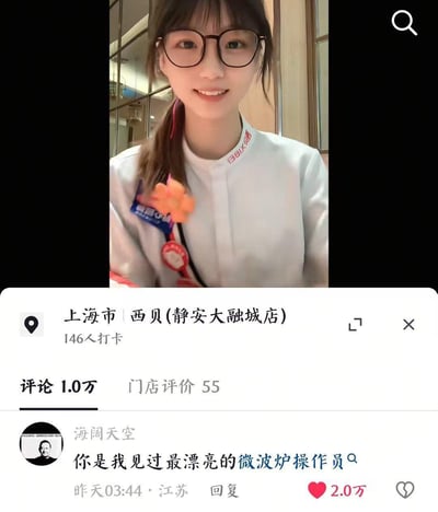 图片上半部分为上海市西贝（静安大融城店）的一位女员工，她穿着白色制服，佩戴姓名牌和橙色花朵装饰，面带微笑看向镜头。下半部分是该门店的社交媒体评论区截图，显示门店有146人打卡、1.0万条评论及55条门店评价，其中一条高赞评论（2.0万赞）来自用户“海阔天空”，内容为“你是我见过最漂亮的微波炉操作员”，整体呈现了餐厅员工因有趣评论受到关注的场景。