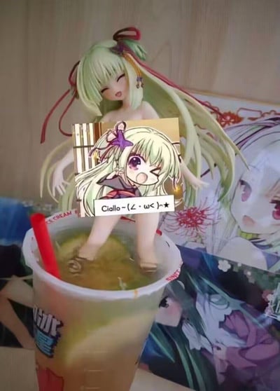 A humorous image showing an anime figurine standing in a cup of tea/liquid as if taking a bath, with an inset image of the same character making a playful expression and saying 'Ciallo~(∠・ω<)⌒★'.