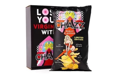 图片展示了一款名为"CHAZZ"的限定版薯片产品，包装设计大胆前卫。主体是一个黑色包装袋，上面印有一位穿着红色紧身衣、戴着红色长手套和长筒袜的金发女性卡通形象，她双腿交叉坐在一堆薯片上，姿态性感。包装上醒目地标注着"PUSSY FLAVOUR"（猫咪风味）和"LIMITED EDITION"（限定版）字样，还有"For the best ones"、"All bodies taste good"等标语。背景是一个黑色盒子，上面印有"LOSE YOUR VIRGINITY WITH CHAZZ"的大胆文字，整体设计充满了成人幽默和讽刺意味。