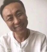 图片中是一位穿着白色上衣的男性，面带明显的笑容，表情亲切自然。背景为纯白色，简洁干净，没有其他多余元素。整体给人一种轻松愉快的感觉。