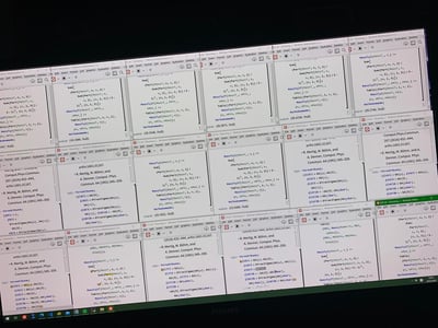 这是一张电脑屏幕截图，画面中密集排列了16个Wolfram Mathematica的运行窗口，每个窗口内都包含用于高能物理领域的符号计算代码：定义了`MassTx2`、`MassTx2T`等用于张量分析的自定义函数，包含求和运算、张量分量提取等操作；同时还引用了多篇计算物理领域的经典文献（如*Comput.Phys.Commun.*期刊的论文），以及狄拉克矩阵相关的定义代码。每个窗口底部都显示了计算输出结果（如`Out[24]= {28.2766, Null}`），满屏的窗口直观体现了科研人员批量运行计算任务的繁重工作状态，是理论物理研究者日常工作的真实写照。