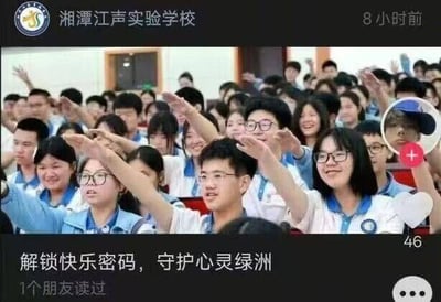 这是一张微信朋友圈的社交媒体截图，发布主体为湘潭江声实验学校。截图中展示了一群身着蓝白相间校服的学生，他们身处室内，不少人举起手，脸上满是开心的笑容，情绪高涨，氛围轻松欢快。截图下方配有文字“解锁快乐密码，守护心灵绿洲”，推测是学校发布的与校园心理健康或相关活动的内容，整体充满青春活力，传递出积极阳光的校园氛围。图中没有双关、谐音梗等特殊内容。