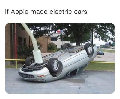 图片上方配有英文文字'If Apple made electric cars'（如果苹果造电动车），下方是一张实拍照片：一辆银色轿车四轮朝天翻倒在地，车底连接着一根白色的类似充电线的物体。整个画面通过夸张的'翻车'场景，幽默讽刺地暗示如果苹果公司生产电动车可能出现的设计缺陷或稳定性问题，带有强烈的调侃意味。