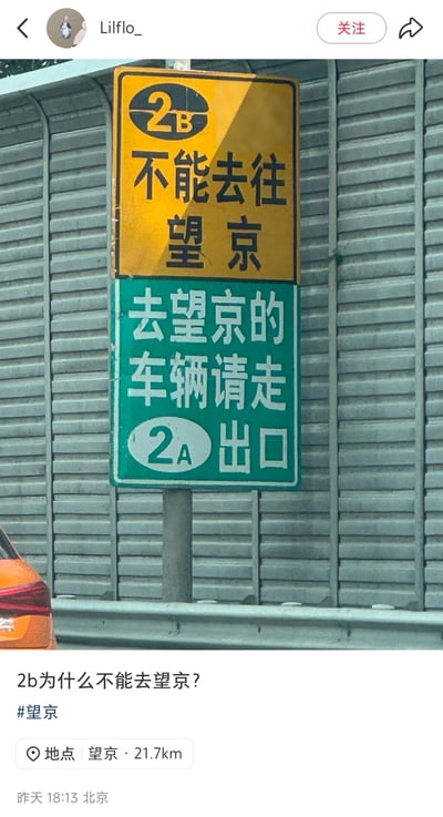 图片展示了一个道路指示牌，上方黄色牌子写着'2B 不能去往望京'，下方绿色牌子写着'去望京的车辆请走2A出口'。这张图在社交媒体上引发疑问'2b为什么不能去望京？'，利用了中文网络用语中'2B'的双关含义（既指2B出口，又指骂人话'二百五'）制造幽默效果。