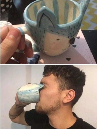 这是一张上下拼接的对比图，上图展示了一个手工制作的陶瓷杯子，杯子整体设计成小动物的形象，拥有立体的浅蓝色耳朵，杯身外侧绘制出小动物的脸部，带有圆圆的眼睛和微笑的嘴巴，杯身内侧是蓝白相间的条纹，造型十分可爱有创意；下图则是一位男士使用这个杯子喝水的场景，由于杯子的动物脸部造型朝向外侧，当男士将杯子凑近嘴边时，杯子的脸部恰好贴在他的脸颊上，形成了一种仿佛这个动物杯子在和他脸贴脸的搞笑视觉反差，让人觉得趣味十足。