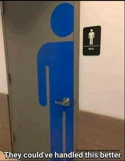 图片展示了一个男厕所的门，门上画着一个巨大的蓝色男性符号，旁边墙上还贴着一个标准的黑色'MEN'标识牌。底部文字'They could've handled this better'（他们本可以处理得更好）点出了这种冗余标识的荒谬感。