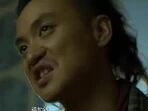 图片为一名长发束起的男性角色截图，背景较暗，人物表情激动，嘴巴张开，似乎正在大声说话或喊叫，整体氛围紧张。