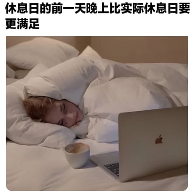 图片展示了一个人舒适地躺在床上，盖着白色的被子，头枕在枕头上，闭着眼睛微笑，显得非常放松和满足。床边放着一台苹果笔记本电脑和一个咖啡杯。图片上方配有文字：'休息日的前一天晚上比实际休息日要更满足'，表达了许多人都有的生活体验——期待休息日的时刻往往比休息日本身更令人感到满足和放松。