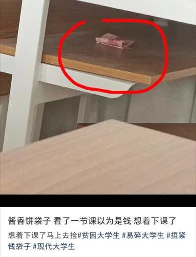 图片上半部分是一张课桌的局部特写，桌面上有一个粉色的酱香饼包装袋，被红色圆圈重点标注出来。下半部分配有文字说明，讲述了一名大学生在课堂上误将酱香饼袋子看成钱，整节课都惦记着下课去捡的趣事，充满了校园生活的幽默与无奈。