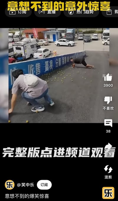 这是一段搞笑短视频的截图，画面呈现户外停车场的下坡区域，地面散落着大量类似小果子的物体，一名背着白色背包的男子正滑倒在地，前方还有一名男子呈俯卧撑姿势趴在地上，显然都是因踩到地面的果子打滑导致的意外。画面顶部配文“意想不到的意外惊喜”，底部配文“完整版点进频道观看”，整体场景充满滑稽感，是记录生活中意外出糗的搞笑内容，无谐音梗或双关含义。