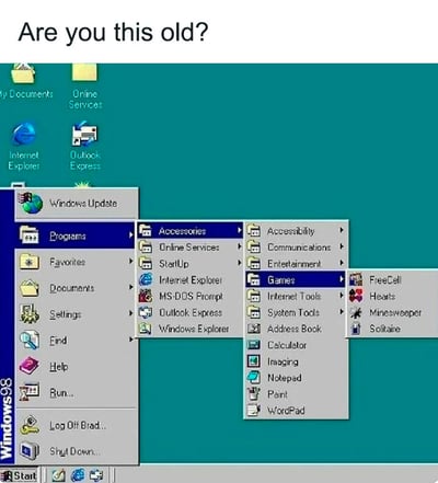 这是一张怀旧向的静态梗图，顶部配有英文提问“Are you this old?”（译为：你有这么老吗？），下方完整展示了Windows 98操作系统的桌面与开始菜单界面：桌面背景是经典的蓝绿色，摆放着“我的文档”“在线服务”“IE浏览器”“Outlook Express”等标志性图标；点击开始菜单后，展开到“程序-附件-游戏”的层级，清晰呈现出空当接龙、红心大战、扫雷、纸牌这些Windows早期自带的经典小游戏，同时还能看到MS-DOS提示符、Windows资源管理器、记事本、画图等当时的经典系统工具与软件。这张图通过唤起用户对Windows 98这个经典老系统的回忆，用调侃的提问方式，筛选出经历过那个电脑早期普及时代的用户，引发同龄人的怀旧共鸣，没有双关、谐音等特殊梗，核心是传递复古怀旧的情绪。