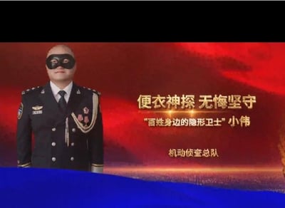 这是一张用于表彰便衣警察的宣传图，画面左侧是一位身着警礼服、佩戴黑色眼罩的光头警察，他站姿端正，面带微笑；背景是红金渐变的庄重色调，右侧配有文字：“便衣神探 无悔坚守”“百姓身边的隐形卫士”小伟“机动侦查总队”，整体氛围庄重肃穆，旨在表彰这位名为小伟的便衣警察长期坚守岗位、默默守护百姓安全的奉献精神。图中不存在双关、谐音梗或暗示类内容。