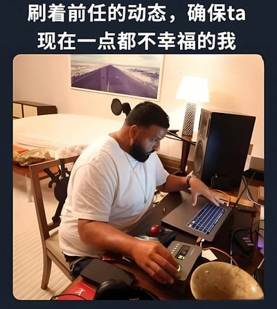 图片上方有文字'刷着前任的动态，确保ta现在一点都不幸福的我'，下方是一名穿着白色T恤的男性坐在书桌前，专注地使用笔记本电脑，桌上有台灯、音箱等物品，背景有一张床和墙上的画。整体营造出一种偷偷关注前任动态，希望对方不幸福的幽默场景。