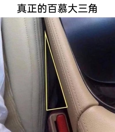 这张图是一张调侃汽车用车痛点的搞笑梗图，图中展示了汽车内饰里车门与中控台衔接处形成的三角形缝隙，并用黄色线条将其标注出来，上方配文“真正的百慕大三角”。现实中的百慕大三角因频繁发生船只、飞机失踪事件而闻名，而这个汽车缝隙是车主日常使用中，小到硬币、钥匙，大到零食碎渣等物品极易掉落进去且难以找回的地方，和百慕大三角“吞掉”事物的特点高度契合，因此被网友调侃为“真正的百慕大三角”，精准戳中了众多车主的日常用车烦恼。