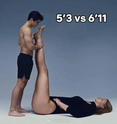 图中展示一名身高约5英尺3英寸（5'3）的男性与一名约6英尺11英寸（6'11）的女性进行互动：男性站立并握住女性向上抬起的腿，女性则仰卧在地，单腿垂直伸展。图片上方以白色粗体字标注'5'3 vs 6'11'，直接点明两人身高差异，形成强烈视觉对比。背景为简洁的浅灰色，无多余元素，突出主体人物的动作与身高关系。底部有水印'@正经的知识'，推测为社交媒体传播内容。整体通过极端身高差与协调的动作组合，营造出幽默搞笑的效果，无谐音或双关含义，属于直观的对比类趣味内容。