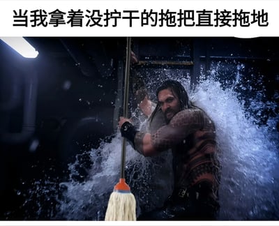 图片上方配有文字“当我拿着没拧干的拖把直接拖地”，下方是电影《海王》中主角亚瑟·库瑞的剧照截图，他被P上了一把拖把，正以充满力量的姿势挥舞，周围水花四溅，将日常拖地的场景夸张成如同超级英雄战斗般的戏剧性场面，营造出幽默搞笑的效果。