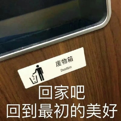 图片展示了一部智能手机放置在木质桌面上，手机屏幕朝下，机身边缘为银色。手机旁边贴有一张白色的“废物箱”标识，标识上有一个黑色简笔画人物正将垃圾扔进垃圾桶的图案，右侧标注了“废物箱”中文及“Dustbin”英文。在标识下方，有一行白色文字：“回家吧 回到最初的美好”。整体画面通过日常物品与文字的组合，形成一种略带讽刺或怀旧的氛围，可能暗示对简单生活的向往与对现代科技产品的调侃。