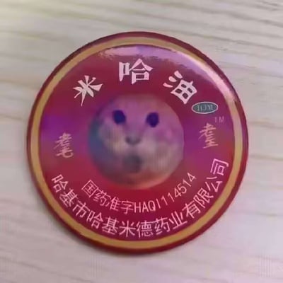 本图为一张网络恶搞梗图。整体以药膏罐盖的样式为主，中央用仓鼠表情包头像替代正品LOGO，四周为模仿哈尔滨米德药业“米哈油”药膏的包装文字。仓鼠呆萌的无辜表情与诚实严肃的药品包装形成了强烈反差，充满幽默感。图中暗藏“米哈油”与二次元公司“米哈游”的谐音梗，将经典药膏包装与流行表情包混搭，是网络文化拼贴、玩梗的典型体现。