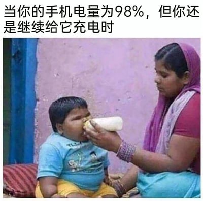 这是一张搞笑梗图，上方配文“当你的手机电量为98%，但你还是继续给它充电时”，图中是一位穿着红上衣配紫色头巾的女性，正拿着食物硬塞给一个看起来已经很胖、满脸不情愿的小男孩，小男孩的抗拒神态和被强行喂食的状态，对应了手机电量还很充足却被继续充电的场景，用生活化的画面调侃了人们过度给手机充电的行为，充满趣味。