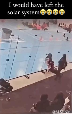 这是一张记录健身房社死瞬间的视频截图梗图，画面呈现健身房内，一名正在使用器械的人因器械滑动，整个人向后狼狈摔倒。图上方配有英文文字“I would have left the solar system”和三个哭脸表情，用夸张的表述来形容当事人此刻尴尬到想立刻逃离的心情，没有双关或谐音梗，通过真实的尴尬场景和夸张文案结合，制造搞笑效果。