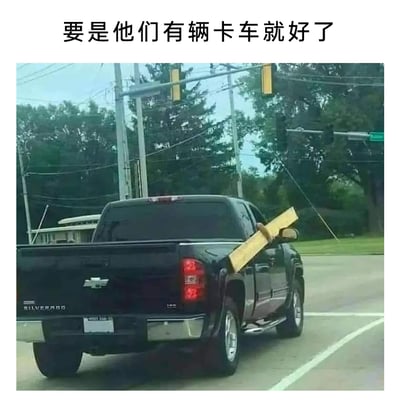这是一张文字加注的原始拍摄横图，画面展示了一辆停在路口的黑色雪佛兰Silverado皮卡，一根长木板从皮卡的货厢中伸出，卡在驾驶座的车窗位置，木板长度远超车身，装载方式非常不合理且滑稽。图片上方配有文字“要是他们有辆卡车就好了”，形成强烈的讽刺反差——明明已经使用了适合装载长物的卡车，却用了完全错误的方式，违背了“卡车适合运长物”的常识，以此制造搞笑效果，让人觉得荒诞又好笑。